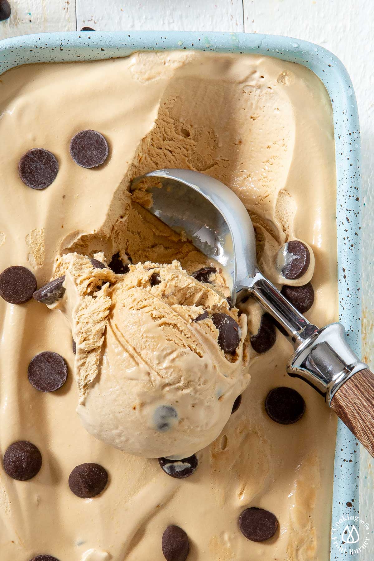 loaf pan with coffee ice cream and a scoop