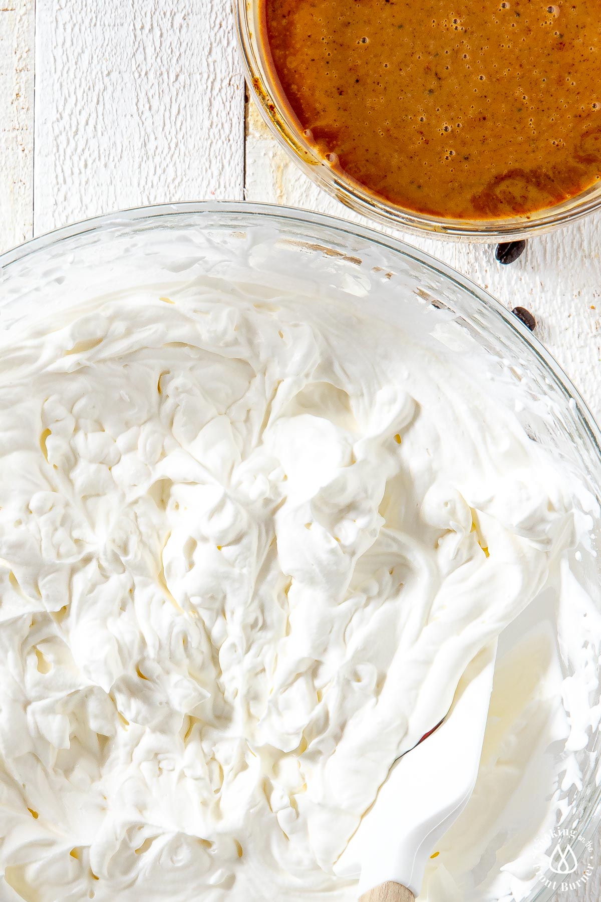 whipped cream in a bowl with stiff peaks