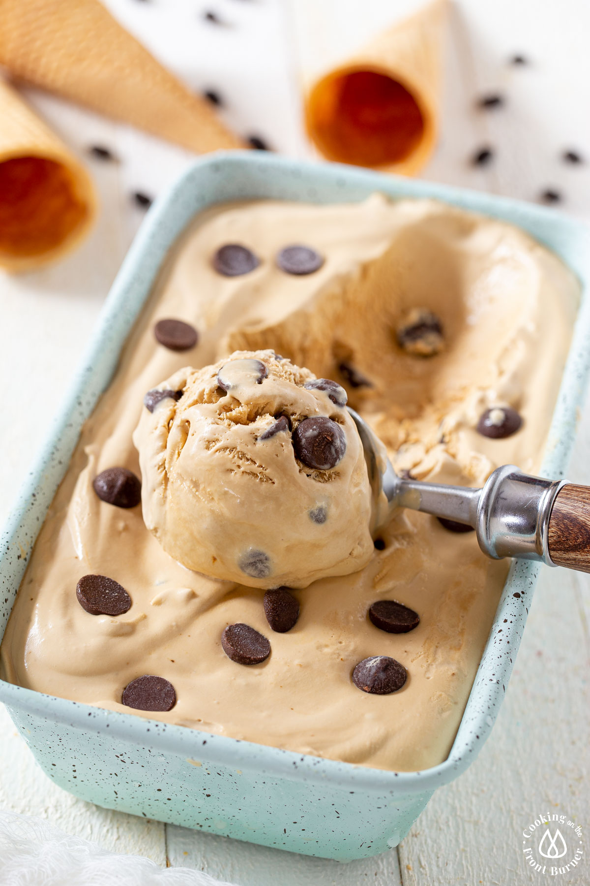 aqua ice cream pan with coffee ice cream and a scoop