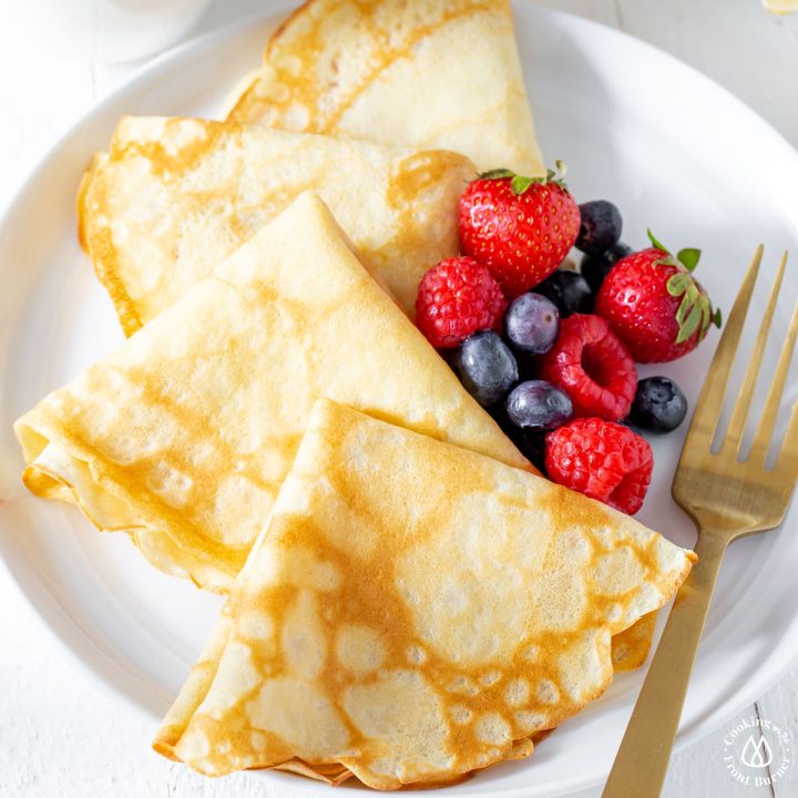 4 crepes on a plate with berries