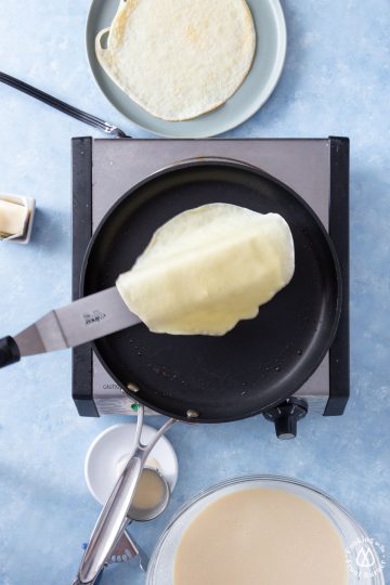 an offset spatula flipping a crepe