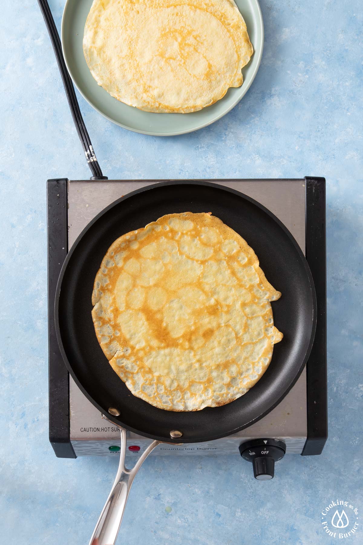 cooked crepe in a pan on burner