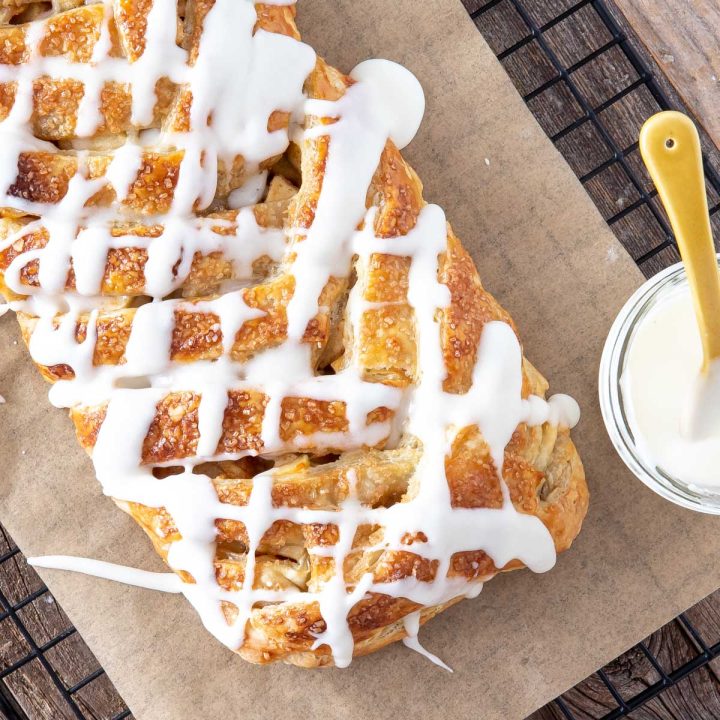 apple strudel with vanilla glaze on parchment paper