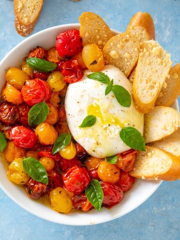 white bowl with burrata cheese and parmesan crisps